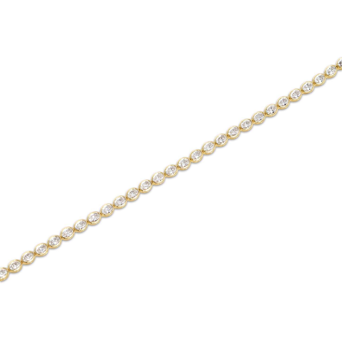 Acute angle view of the Oval Bezel Set East West Tennis Bracelet featuring 5.5ct oval-cut lab-grown diamonds in EF color, VS clarity, set in 14K yellow gold, showcasing the elongated bezel settings and elegant curvature of the bracelet