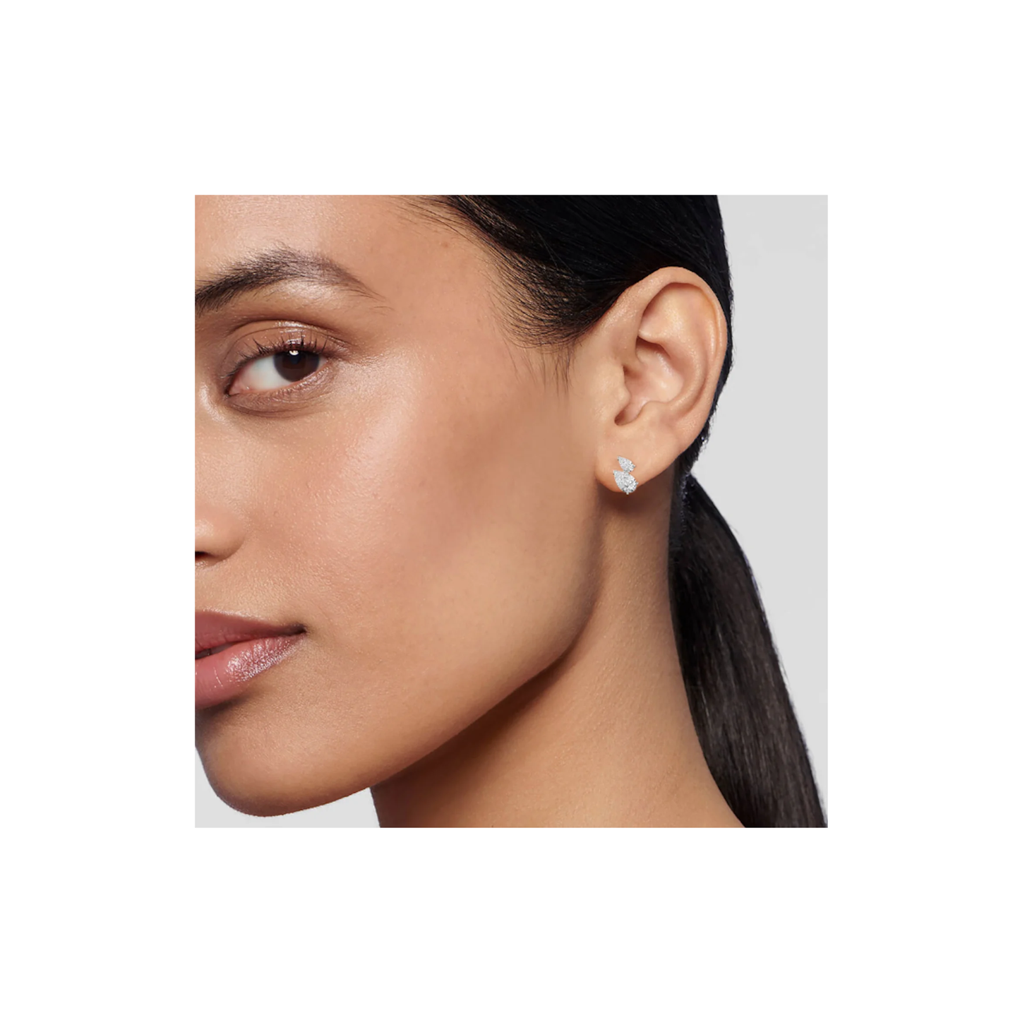 Close-up lifestyle portrait featuring pear shaped diamond climber earrings in 14K gold elegant contemporary fashion style