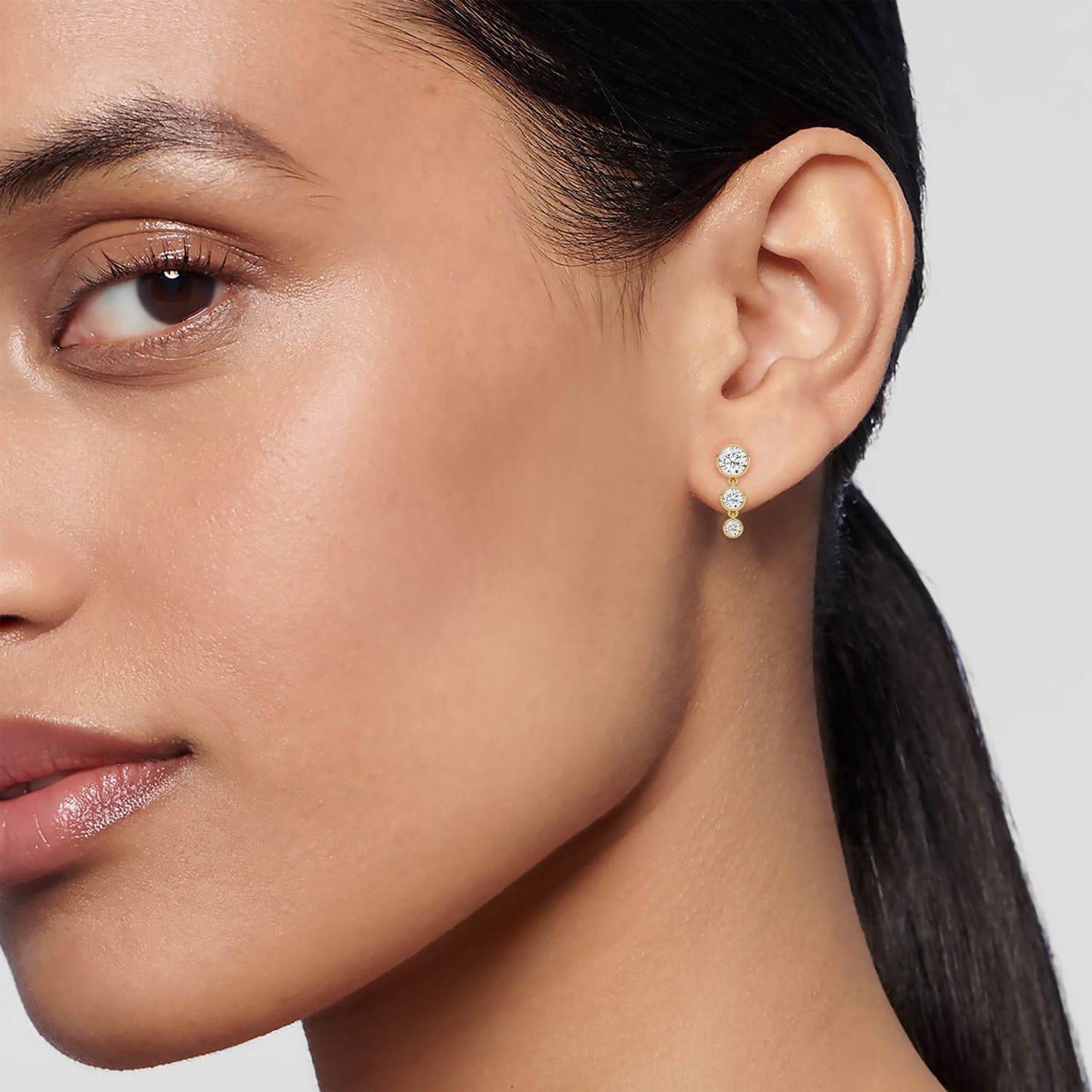 Elegant Eva earrings by Lumeniri featuring three round lab grown diamonds in bezel-set dangle style