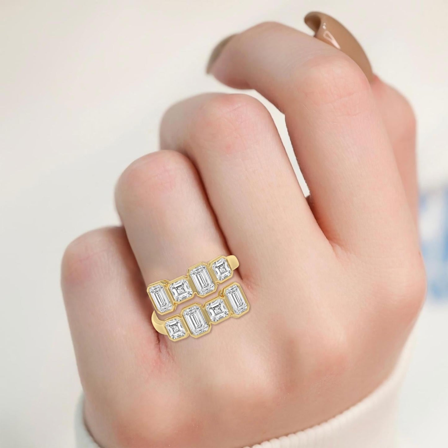 Elegant bypass ring by Lumeniri featuring emerald and Asscher lab grown diamonds in bezel settings, crafted in 14K yellow gold