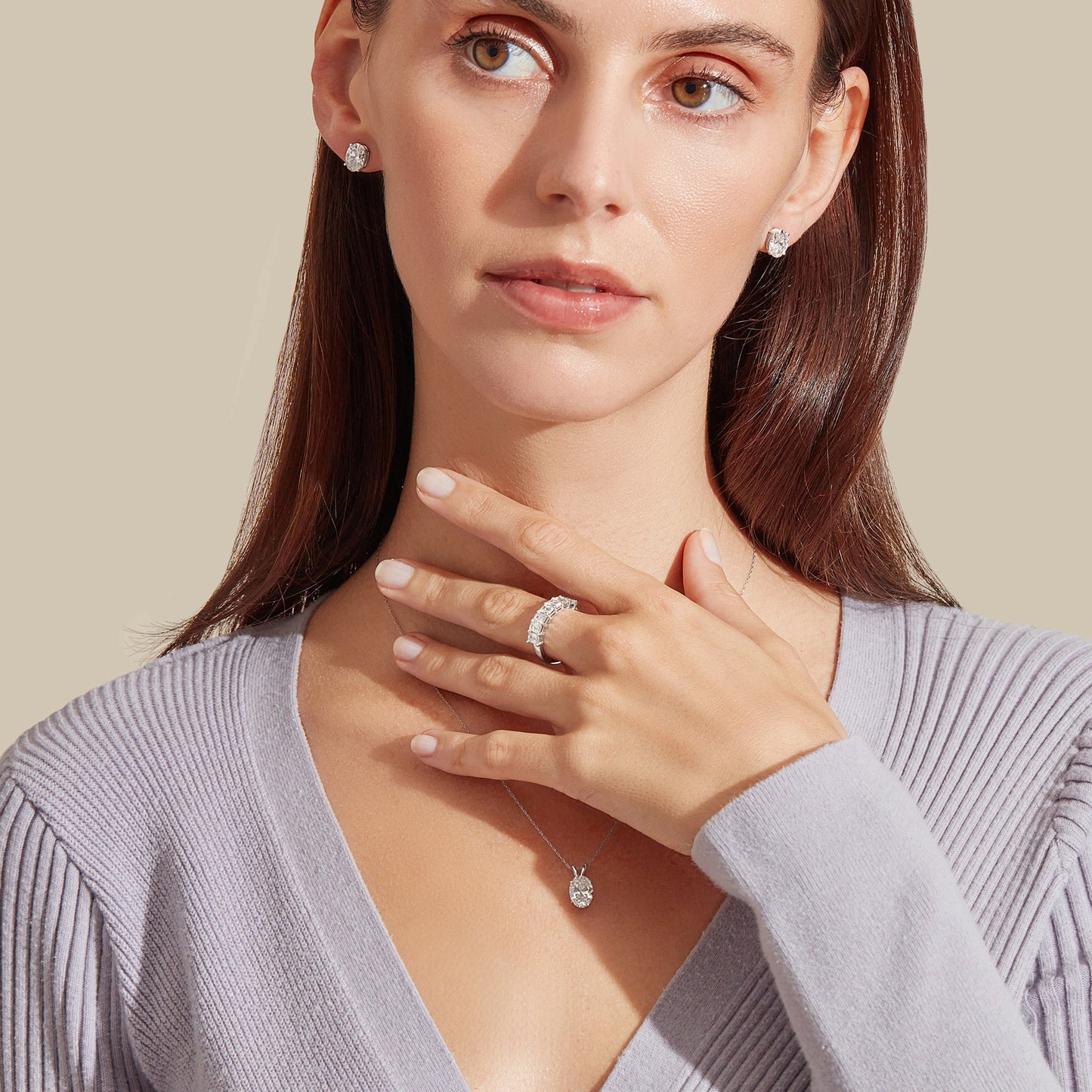 Lumeniri Classic Oval Stud Earrings displayed in ear, featuring 3cttw of stunning lab-grown diamonds set in 14K White Gold, exuding refined brilliance.