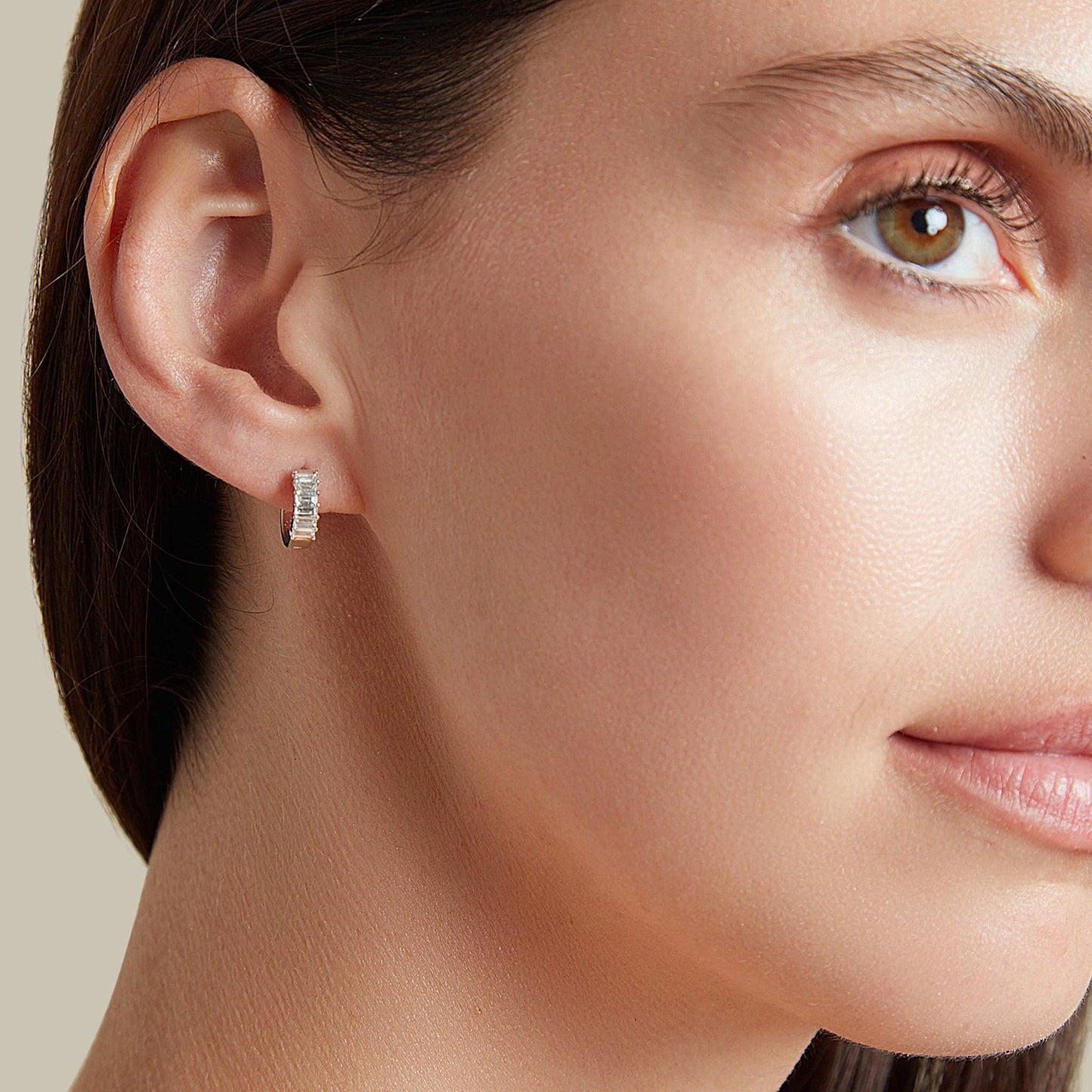 Lumeniri Halina baguette huggie earrings worn on ear, showcasing 0.45ct lab grown diamonds in 14K gold elegant modern fine jewelry styling.