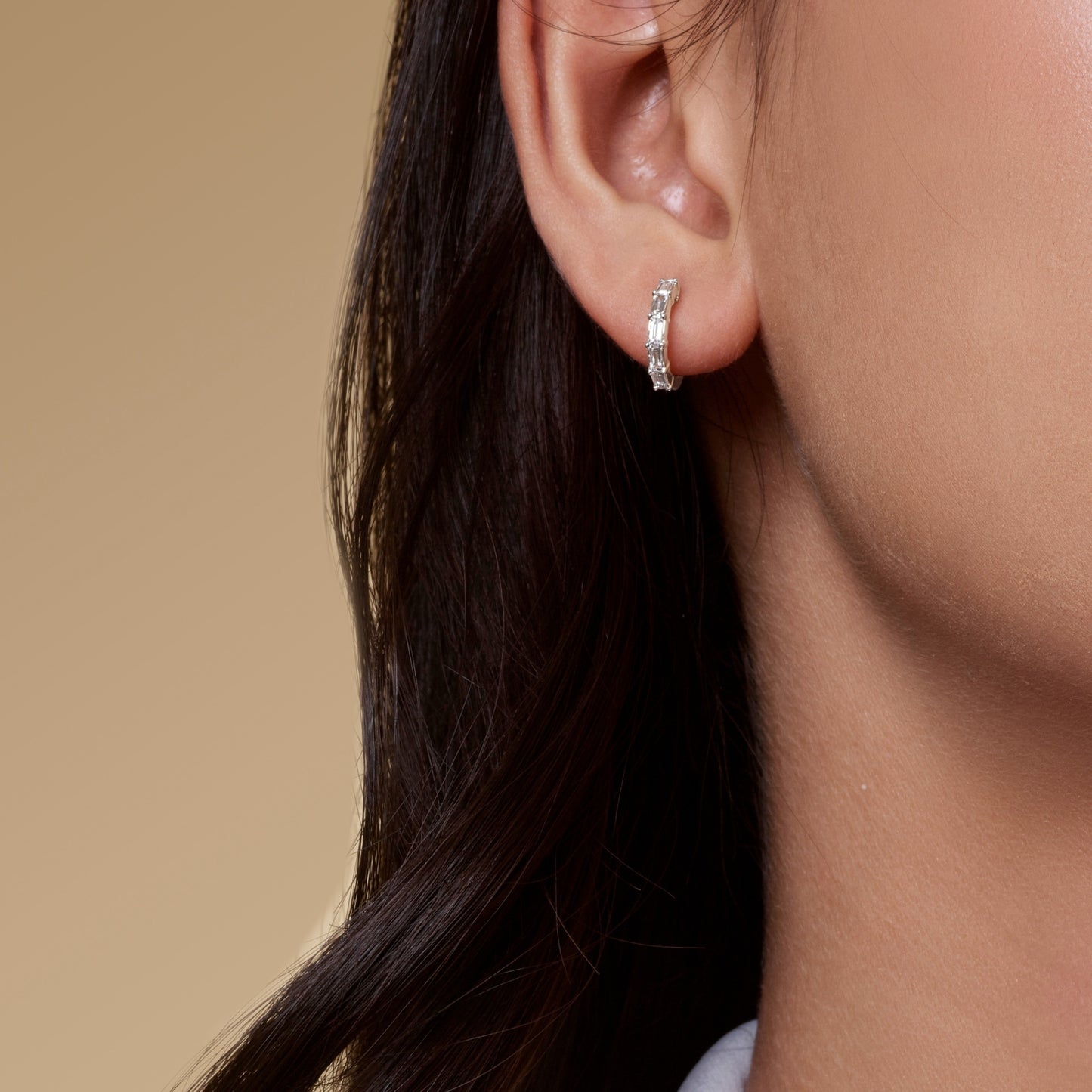Lumeniri Halina vertical baguette cut huggie hoops worn on ear, showcasing 0.45ct lab grown diamonds in 11mm 14K gold modern fine jewelry styling and elegant everyday luxury.