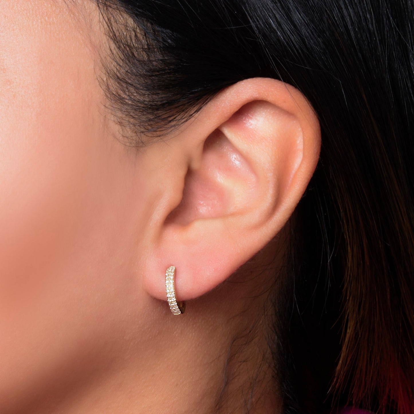 Lumeniri Kamali pavé huggie earrings worn on ear, showcasing 0.16ct lab grown diamonds in 14K gold elegant modern fine jewelry styling.