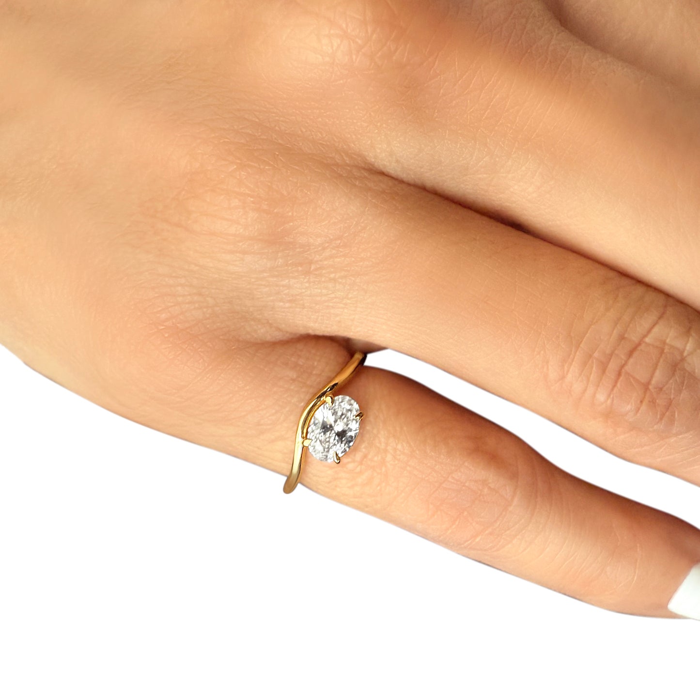 Lumeniri The Aria Pinky Ring worn on hand, featuring 0.75ct oval lab grown diamond in east-west orientation with sculptural wave 14K gold band, elegant modern pinky ring styling for everyday wear.