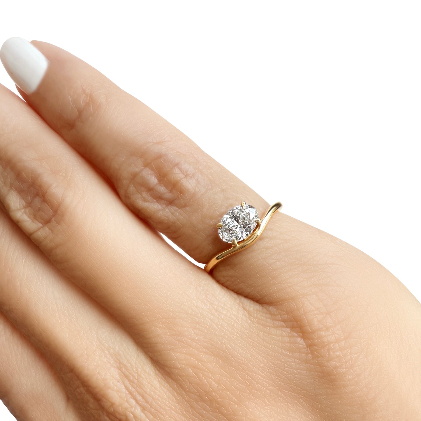 Lumeniri The Aria Pinky Ring worn on hand, showcasing 0.75ct oval lab grown diamond in east-west setting with sculptural wave 14K gold design, elegant minimalist fine jewelry styling.