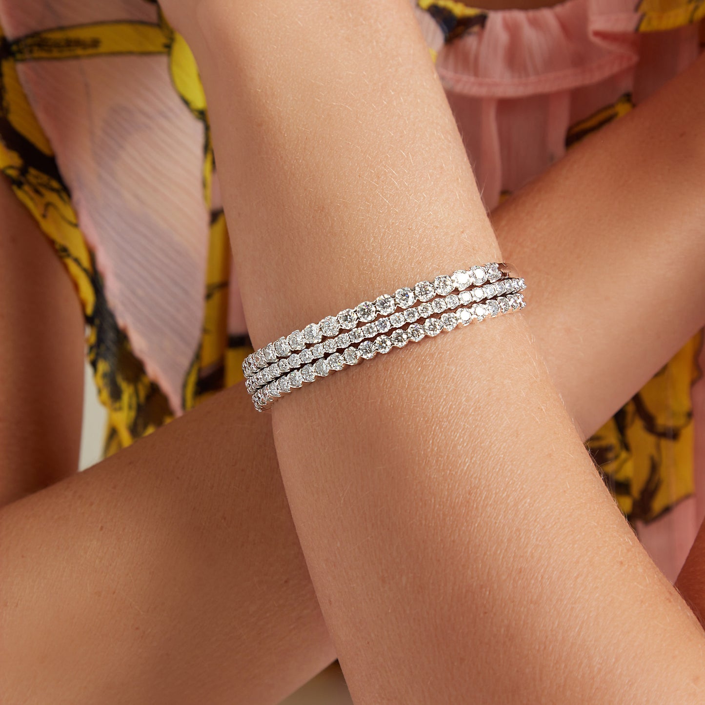 Lumeniri The Claire 3ct tennis bracelet styled on wrist, highlighting brilliant lab grown diamonds in classic 4 prong 14K white gold setting, refined modern jewelry look.