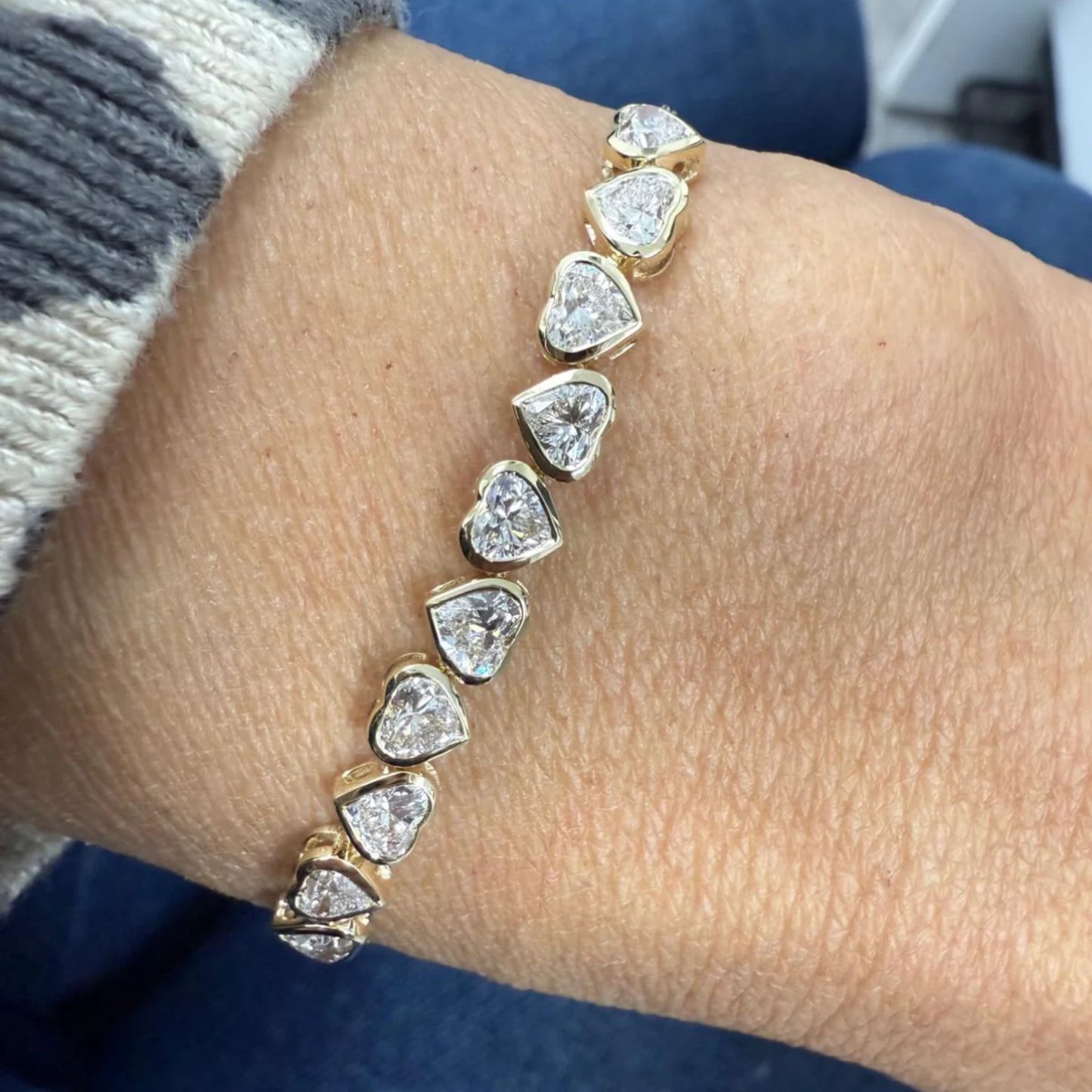 Lumeniri The Lucia Heart Half Tennis Chain Bracelet worn on hand, showcasing 2.0ct lab grown heart and round diamonds in 14K gold modern elegant fine jewelry styling.
