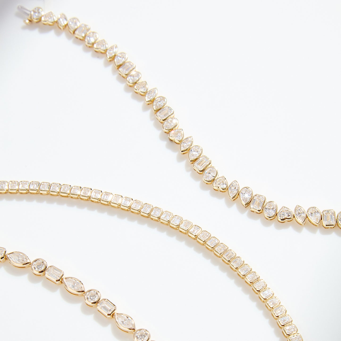 Lumeniri The Lucia mixed fancy shape tennis bracelet by Lumeniri showcasing north-south bezel set diamonds in handcrafted 14K gold fine jewelry design.