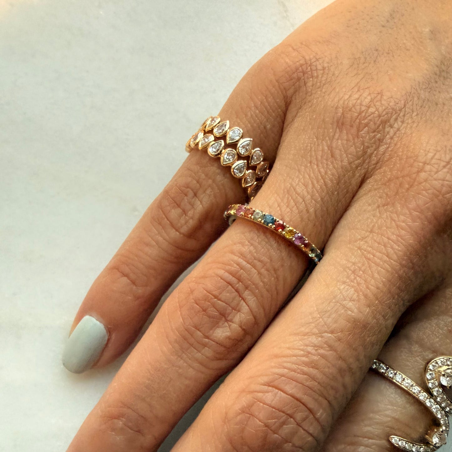 Modern and timeless pinky ring with bezel-set pear lab-grown diamonds in full 14K yellow gold band