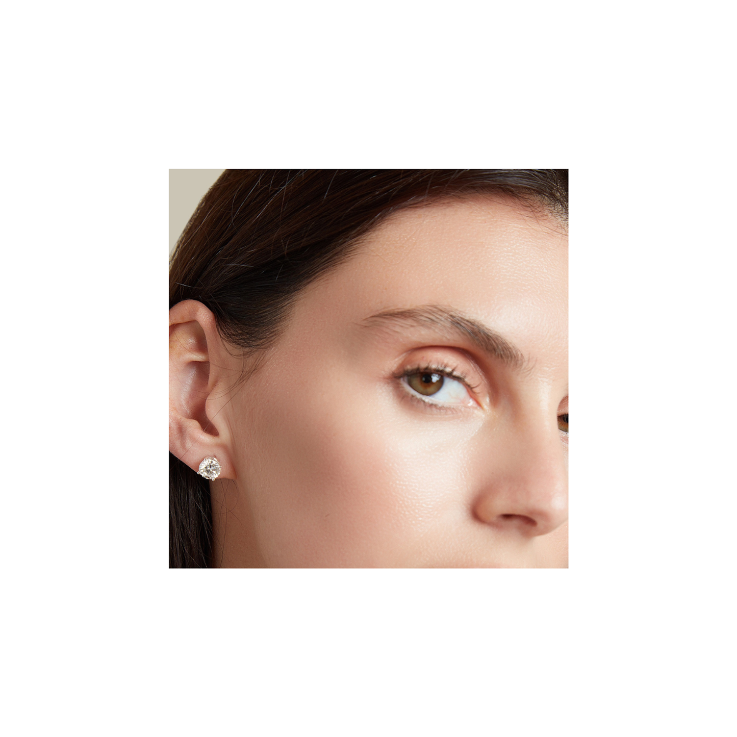 Woman wearing 3.00cttw round lab-grown diamond stud earrings in 14K white gold elegant look